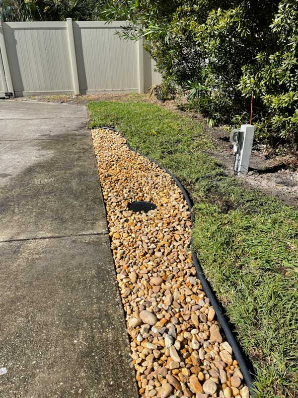 Finished drainage system with decorative gravel border