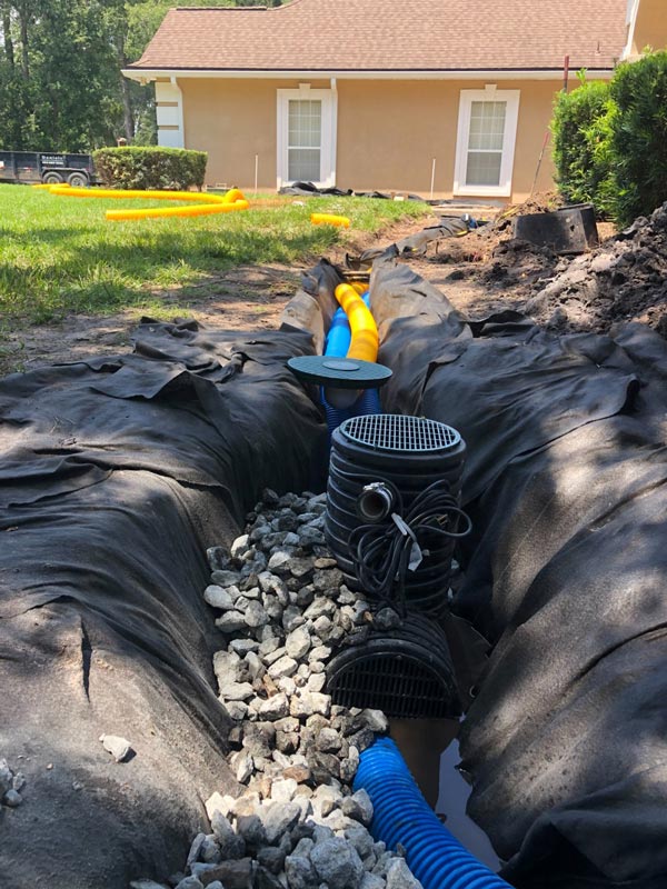 Long drainage trench with drain pipe during installation
